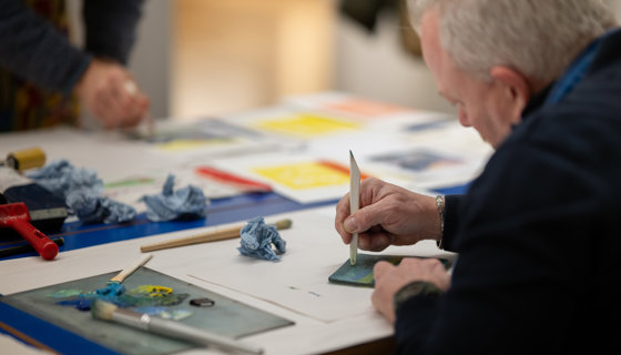 older man making art