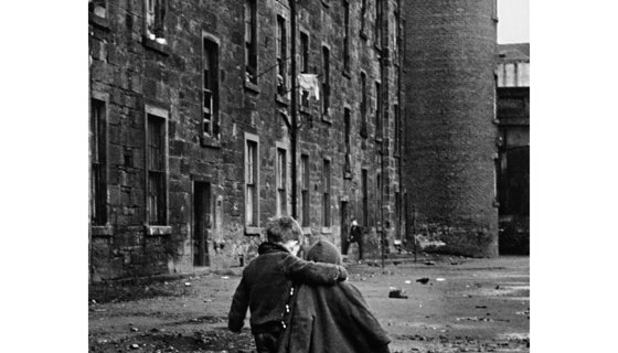 two children walking down a street