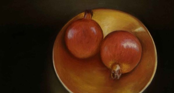 2 Pomegranates sitting in a bowl